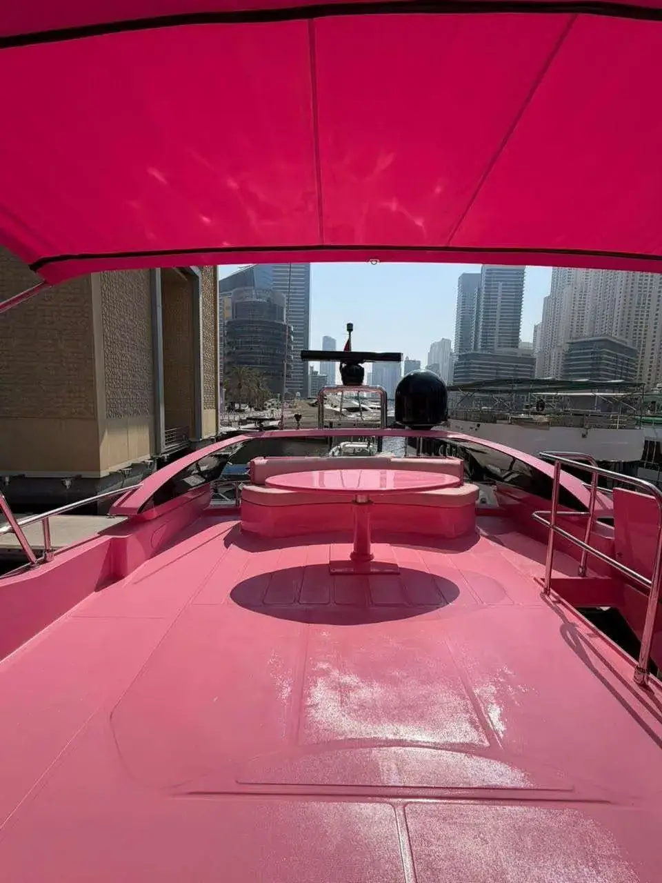 Open flybridge deck of the Pink Yacht with the Dubai Marina skyline