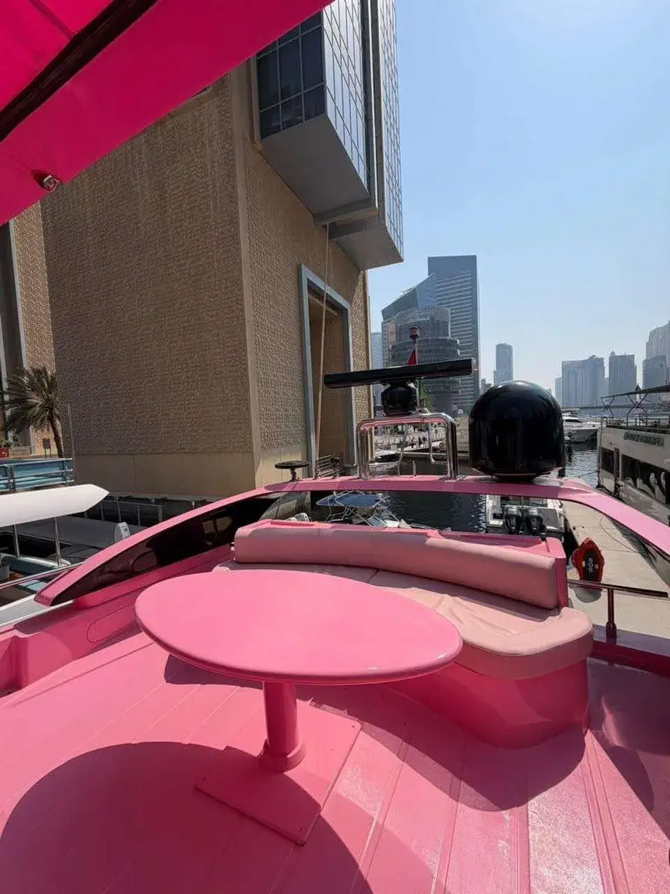 Flybridge dining table under the pink bimini on the Pink Yacht