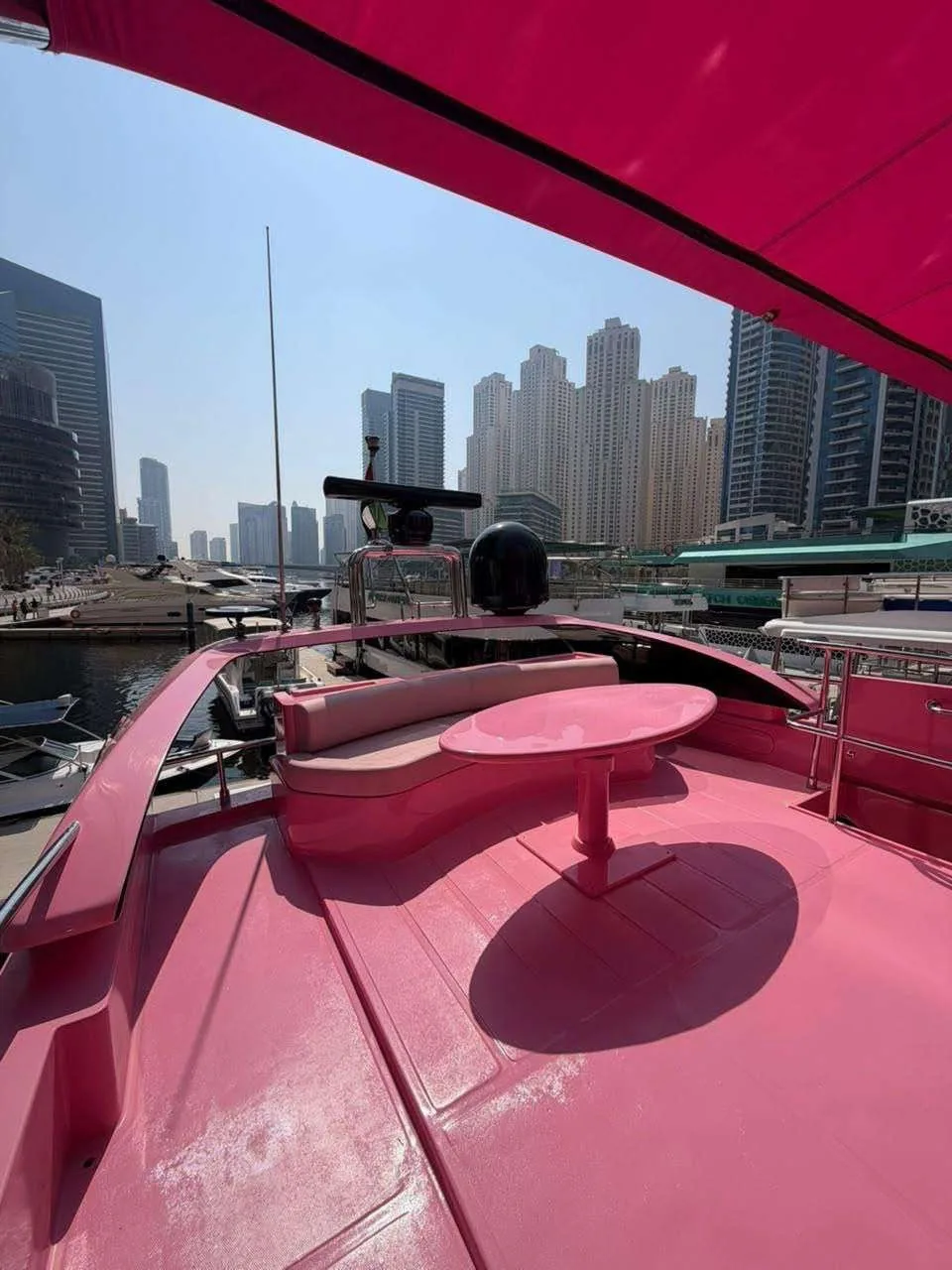 Comfortable shaded seating on the pink yacht's flybridge